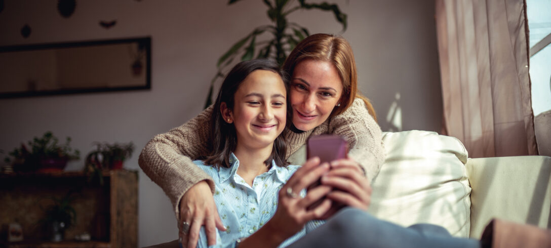 mère et fille s'embrassant en regardant une vidéo sur youtube